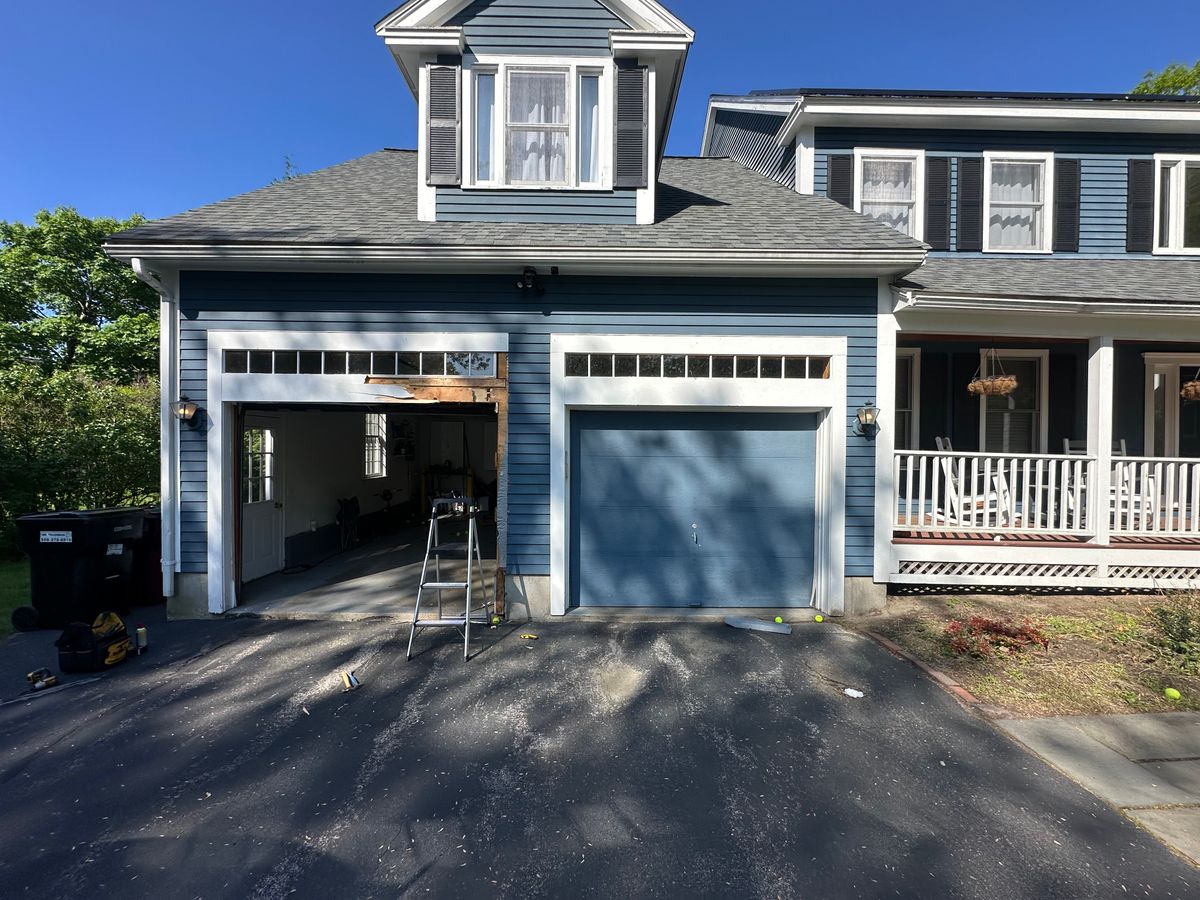 Blue garage door installation in progress on colonial home with ladder — Middlesex County, MA