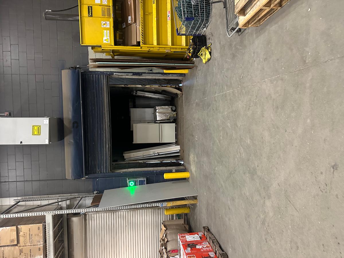 Commercial loading-bay roll-up door in open position inside Massachusetts warehouse